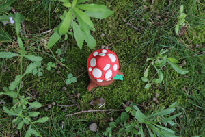 Mycota sitting on a log in gray resin