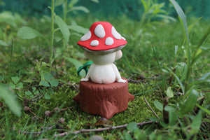 Mycota sitting on a log in gray resin