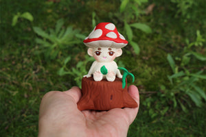 Mycota sitting on a log in gray resin