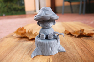 Mycota sitting on a log in gray resin