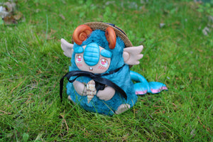 Autumn troll asleep with a cycat on its back